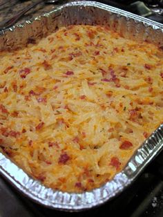 a casserole dish with cheese and bacon in it on a stove top, ready to be eaten