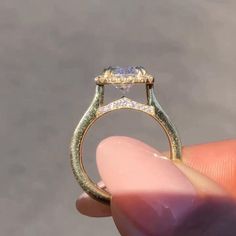 someone is holding an engagement ring with a diamond on it's sidestrap