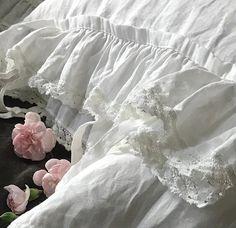 white ruffled bedspreads with pink flowers on them