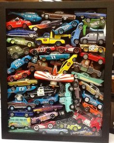 a shadow box filled with toy cars on top of a table