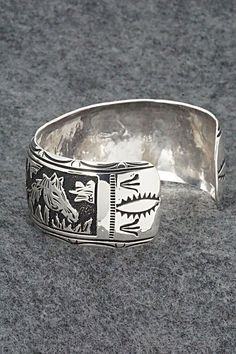 This expertly crafted sterling silver bracelet featuring horses was made by Navajo silversmith Richard Singer. The back is signed R Singer and stamped .925.Size: 5 5/8" (will fit up to a 6 3/4" wrist)Gap: 1 1/8"Width: 1"Free shipping on all orders! We ship with USPS and always include tracking. All orders ship within a day of payment.Returns are accepted up to 30 days after you receive your order. Just send us a message. Our shop offers cash back or store credit. The item must be returned in new Western Sterling Silver Cuff Bracelet Gift, Western Sterling Silver Adjustable Bracelet Stamped 925, Western Sterling Silver Cuff Bracelet, Adjustable Sterling Silver Western Cuff Bracelet, Adjustable Sterling Silver Western Bracelet, Western Sterling Silver Bracelets, Adjustable Western Sterling Silver Bracelet, Western Style Sterling Silver Cuff Bracelet, Southwestern Etched Bracelets For Collectors