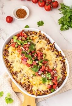 a casserole dish filled with mexican food and garnished with cilantro