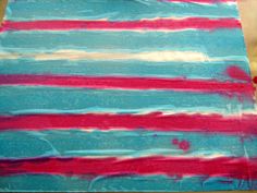 a piece of fabric that has been dyed red, white and blue with stripes on it