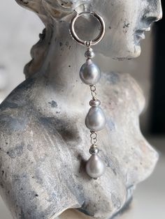 Make your mother sigh (but not actually) with these tear drop dangle earrings featuring baby grey keshi button pearls and grey pear shaped freshwater pearls. These earrings are one of a kind and handmade in Los Angeles. Features: Comes as a pair Length from end of hoop to end of earring is 1.5 inches .925 sterling silver wire and click back hoops Silver Teardrop Earrings With Pearl Charm As Gift, Silver Teardrop Earrings With Pearl Charm, Silver Teardrop Pearl Earrings, Gray Pearl Drop Jewelry For Gift, Silver Tahitian Pearl Earrings For Wedding, Sterling Silver Gray Dangle Jewelry, Gray Sterling Silver Dangle Jewelry, Silver Drop Pearl Single Earring, Silver Teardrop Tahitian Pearl Jewelry