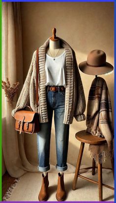 Stay comfortable and stylish this fall with a casual and cozy outfit! Featuring a chunky knit cardigan in a soft oatmeal color layered over a white t-shirt, paired with distressed blue jeans, this look is perfect for everyday wear. Brown suede ankle boots, a plaid scarf, and a wide-brimmed hat complete the ensemble, adding a touch of fall flair. Ideal for those who love relaxed and seasonal style. #FallFashion2024 #CasualOutfit #CozyStyle #AutumnVibes Cardigan With Belt Outfit, Brown Suede Ankle Boots Outfit, How To Style Brown Boots Ankle, Outfits With Brown Boots Ankle, Jeans And Brown Boots Outfit, Soft Autumn Outfit Ideas, Brown Boots Outfit Ankle, Brown Scarf Outfit, Brown Boots Outfit Winter