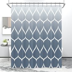 a bathroom with a shower curtain that has an abstract design on the front and back