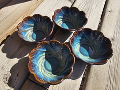 three bowls sitting on top of a wooden table