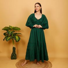 Bohemian medieval-inspired cotton dress with elastic under the bust for a perfectly fitted look. This Elegant piece has puffed sleeves tightened at the wrist with a wooden button. Soft, comfortable and breathable linen-look cotton.  Ideal top for a party, wedding or medieval celebration Free Size Main Color:  Bottle Green 100% Cotton First Wash Seperetly Machine wash 30o No Dryer Dry in the Shade to Protect the Color Handmade Delivered In A Cloth Pouch And Wrapped In Tissue Paper Ideal For Gifti Puff Sleeve Cotton Maxi Dress With Ruffles, Cotton Maxi Dress With Ruffles And Puff Sleeves, Long Sleeve Cotton Peasant Dress, Cotton Peasant Prairie Dress With Ruffles, Cotton Prairie Dress With Ruffles In Peasant Style, Green Bohemian Dress, Cloth Pouch, Fitted Maxi Dress, Dress With Ruffles