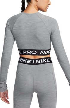 Nike Pro lettering details the stretchy, cropped hem of a second-skin top designed with sweat-wicking Dri-FIT tech that helps you stay dry and comfortable. 13 1/2" length (size Medium) Crewneck Long sleeves with thumbhole cuffs Dri-FIT moisture-wicking technology 83% polyester, 17% spandex Machine wash, dry flat Imported Nike Athletic Heather Sportswear Tops, Nike Fitted Tops For Sports Events, Fitted Nike Tops For Sports Events, Nike Athleisure Activewear With Letter Print, Sporty Fitted Athletic Heather Top, Fitted Athletic Heather Tops For Athleisure, Nike Gray Stretch Top, Nike Athleisure Crop Top For Sports, Nike Athleisure Crop Top For Gym