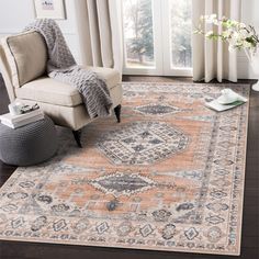 a living room area with a chair, rug and window