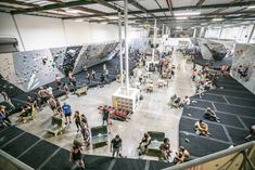 an indoor climbing gym with lots of people