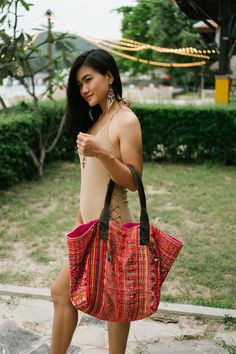 "The beautiful tote bag designed by oriental inspiration for lazy days at the beach and wandering around. It is made with an amazing piece of fabric woven by the HMONG hill tribes of Lanna Region (Northern Thailand). It features cotton lining, Leather Straps and a zipper closure. This bag will enhance your appearance. We buy materials from Hmong market and we design and sew by hand. Some of the bags we modify to improve the product. The Hmong tribes live in the North of Thailand and have origins Traditional Tote Beach Bag For Travel, Traditional Tote Bag For Vacation, Traditional Tote Beach Bag, Traditional Tote Beach Bag For Everyday Use, Red Handwoven Beach Bag For Travel, Handmade Traditional Beach Bag For Travel, Bohemian Hobo Bag For Beach Season Travel, Traditional Shoulder Beach Bag For Daily Use, Traditional Tote Shoulder Bag For Vacation