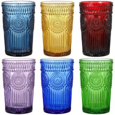 four different colored glass tumblers sitting next to each other