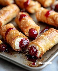 croissants with jelly and cream filling on a baking sheet, ready to be eaten