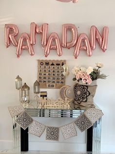 a table topped with balloons that spell out the word rama