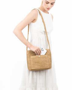 A women's designer crossbody bag for sale online of woven raffia with top zipper closure is super cute for use throughout spring-summer months. The textured weave is intricate with its long strap extending down the sides of the bag body. The mid-size rectangular shape is soft and squishy and feels body friendly. A roomy outer pocket on reverse is for easy access to phone or glasses. Inside: durable cotton canvas lining, sidewall zipper compartment and roomy patch pocket. Dimensions: Front and ba Beige Braided Crochet Bag, Natural Color Crochet Bag With Woven Leather, Natural Colored Crochet Bag With Woven Leather, Spring Braided Brown Shoulder Bag, Square Shoulder Bag With Intrecciato Weave For Travel, Trendy Natural Braided Shoulder Bag, Spring Braided Crochet Shoulder Bag, Spring Brown Handwoven Shoulder Bag, Chic Woven Natural Fiber Shoulder Bag