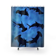 a blue shower curtain with black silhouettes of sea animals