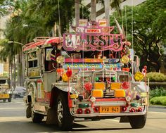 an elaborately decorated bus drives down the street