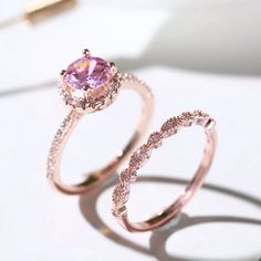 This Set Includes Two Rings. Each Band Is Plated With 18k Rose Gold. The Eternity Band Has An Art Deco Design And Is Adorned With Cz’s. The Engagement Ring Features A Halo Design With A 2 Carat Pink Sapphire And Smaller Cz’s Adorning The Rest Of The Band. Material: 18k Rose Gold Plated Size: 6, 7, 8 Promise Ring Band, October Pink, Pink Zircon, Birthstone Stacking Rings, Engagement Gifts For Her, Diamond Promise Rings, Trendy Ring, Elegant Ring, 925 Silver Jewelry