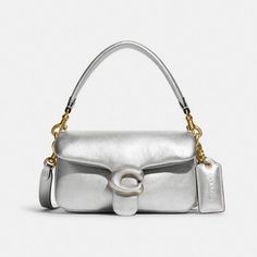 New! Coach Pillow Tabby 18 Metallic Silver Shoulder Bag $450 New Without Tags! 100% Authentic Color: Metallic Silver *Color May Look Different Due To Lighting. Details: Metallic Soft Calf Leather Inside Multifunction Pocket Snap Closure, Leather Lining Detachable Handle With 4" Drop. Detachable Long Strap With 21 1/2" Drop For Shoulder Or Crossbody Wear. Approximate Measurements: 7 1/4" (L) X 4" (H) X 2 1/2" (W) Brand New, Never Worn No Tags! May Have Minor Imperfections Such As Scratches And Cr Luxury Metallic Silver Shoulder Bag, Silver Designer Shoulder Bag With Detachable Strap, Designer Silver Crossbody Bag, Classic Silver Crossbody Shoulder Bag, Luxury Silver Satchel Shoulder Bag, Classic Silver Shoulder Bag With Detachable Strap, Classic Silver Crossbody Bag, Designer Silver Bag With Detachable Strap, Luxury Metallic Silver Bag For Formal Occasions