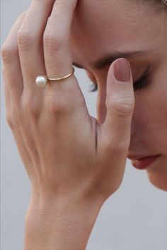 Beautiful and Timeless Ring with a white freshwater pearl, crafted in 14kt yellow gold. A big trend in 2020 - beloved by fashion icons on and off the runways. #klenota #klenotajewelry #ring #klenotaring #pearls #pearlrings #yellowgold #14k#14carat #minimalistic #valentinegift #giftideas #simple #pearls #anniversary #anniversaryrings #freshwaterpearl #pearljewelry
#minimalistic #statement #bestgift Timeless 14k Gold Bypass Ring, Yellow Gold Solitaire Open Band Jewelry, Solitaire Yellow Gold Open Band Jewelry, Classic Akoya Pearl Drop Rings, Classic Pearl White Rings With Pearl Drop, 14k Yellow Gold Rings With Pearl Charm, Timeless Solitaire Pearl Promise Ring, Formal Akoya Pearl Drop Rings, Gold Pearl Drop Ring In Classic Style