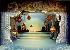 a stage set with lanterns hanging from the ceiling