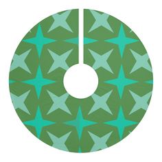 a green and blue star pattern with a white circle in the middle that is hanging from it's center