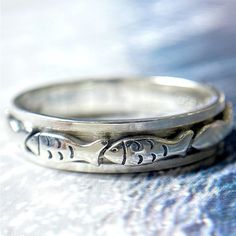 The fishes are very helpful in increasing the good luck of the house. This ring design is inspired by the swimming fishes. Spin the fish band, enjoy prosperity and good luck.  If you are looking for a unique and stylish gift for your friends and yourself who loves fish or fishing? Look no further than the Swimming Fish Spinner Ring, Christian Fish Ring, Men's Fish Ring, Fish Ring Design, Anxiety Ring Sterling Silver Fidget, Animal Ring! This sterling silver ring features a beautiful fish design Coastal Jewellery, Swimming Fish, Fish Ring, Meditation Rings, Animal Rings, Funky Jewelry, Spinner Ring, Spinner Rings, The Fish