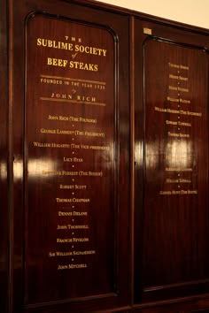 two wooden walls with plaques on them in front of a wall that says sublime society beef steaks