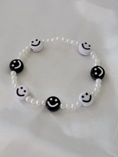 a bracelet with black and white beads and smiley faces