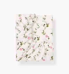 a white sheet with pink flowers on it and a ruffled edge in the middle