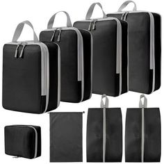 six pieces of black and white bags with zippers on each side, all lined up