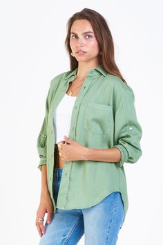 Oversized shirt with drop shoulder, button front long sleeve finished with rolled cuff tab & cuff band, back yoke, curved hem. Besties forever... unconditional casual & cozy support in all you do! Solid color woven on relaxed fit.Body length from HPS: 28 1/2", Sleeve length: 22", Bust: 44" (Size Small) 100% TENCEL Machine wash cold, Tumble dry low Imported Trendy Long Sleeve Shirt With Roll-up Sleeves, Trendy Long Sleeve Tops With Roll-up Sleeves, Trendy Green Collared Shirt, Casual Olive Long Sleeve Shirt, Casual Long Sleeve Shirt With Cuffed Sleeves, Green Summer Shirt With Roll-up Sleeves, Summer Long Sleeve Shirt With Cuffed Sleeves, Trendy Button-up Shirt With Rolled Sleeves, Green Relaxed Fit Shirt With Button Cuffs