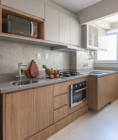 a kitchen with wooden cabinets and stainless steel appliances