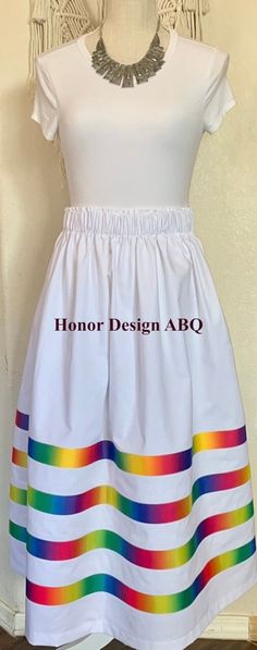 "Traditional ribbon skirt with ombre rainbow grosgrain ribbon on solid white skirt finished with elevated details and lovingly made by hand. A paper bag waist hugs the body, while also being comfortable to wear. See our sizing details below.  Ready to ship! A long time symbol femininity, sisterhood and solidarity, used in ceremony and everyday, every skirt tells a story written by the woman who wears it. Perfect for every season, dressed up or down. Satin ribbons adorn our skirts and are chosen and arranged by hand during the design process. Each skirt is one of a kind, and may be the only skirt available in the indicated size, fabric, and ribbon combination. We recommend buying the skirt before it sells out, we cannot guarantee stocking certain fabric and ribbon combinations due to the na Rainbow Ribbon Skirt, Ribbon Skirts Native American, Ribbon Combinations, Time Symbol, Indigenous Style, Ribbon Skirt, Skirt Ideas, Native Crafts, Rainbow Ribbon