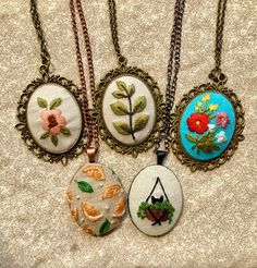 Hand-embroidered Pendant Necklaces  Another round of the beautiful, intricately-detailed hand-embroidered necklaces made by shop member, Amy C. These necklaces are such timeless accents to add to your outfits and make excellent gifts. Bohemian Necklaces With Motifs As Gift, Bohemian Necklaces With Motifs For Gift, Traditional Oval Handmade Necklaces, Traditional Handmade Oval Necklace, Traditional Oval Handmade Necklace, Vintage Embroidered Jewelry, Traditional Handmade Oval Pendant Necklace, Bohemian Embroidered Pendant Necklace, Bohemian Embroidered Beaded Necklaces As Gift