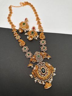 Floral Peacock Design CZ Matte Finish Ethnic Long  Necklace with Screw Back Earrings. Traditional Necklace pair it up with sarees or Lehengas. Perfect for this festive season. Necklace Length : 24 Inches;  Earring Length : 2 Inches Approx. Screw Back Premium quality and craftmanship Ready to ship from Boston, Massachusetts. If you have any questions please let me know. Festive Bollywood Jewelry Sets With Peacock Design, Festive Multicolor Peacock Design Jhumkas, Festive Multicolor Peacock Jhumkas, Diwali Peacock Design Chandbalis For Puja, Festive Peacock Design Jewelry Sets, Festive Chandbali Temple Necklace With Peacock Design, Bollywood Style Multicolor Peacock Jhumkas, Festive Peacock Design Chandbalis, Festive Peacock Design Chandbalis For Festivals