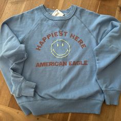 American Eagle Trendy Blue T-shirt For Fall, Casual Light Blue Sweatshirt With Letter Print, Light Blue Graphic Print Sweatshirt For Fall, Fall Light Blue Sweatshirt With Graphic Print, Blue T-shirt For Everyday Fall Wear, Light Blue Letter Print Sweatshirt For Fall, Blue Everyday T-shirt For Fall, Cute Soft-washed Blue Tops, Blue Crew Neck Screen Print Top