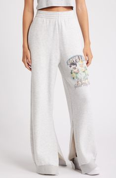 An oversized graphic brings big brand energy to these terry-knit sweatpants styled with comfortable wide legs. 30 1/2" inseam; 10 1/2" leg opening; 13 1/4" front rise; 15 1/2" back rise Elastic waist Side-seam pockets Side slits 66% cotton, 21% rayon, 13% rayon Machine wash, tumble dry Imported Trendy Oversized Loungewear Pants, Casual Oversized Bottoms With Graphic Print, Sporty Wide Leg Bottoms With Letter Print, Trendy Wide Leg Sweatpants With Letter Print, Cotton Sweatpants With Letter Print, Letter Print Sweats For Spring Loungewear, Casual Full Length Sweatpants With Letter Print, Oversized Bottoms With Letter Print For Spring, Sporty Wide Leg Sweatpants With Letter Print