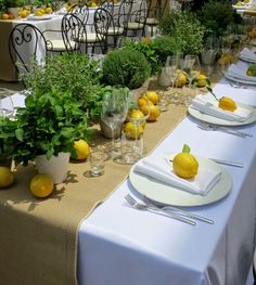 there is a table set with lemons and place settings on it for an event