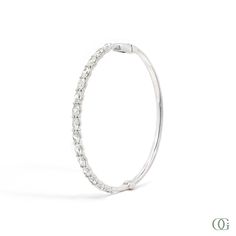 This Oval Diamond Bangle features an exquisite oval-shaped diamond set in a timeless design. Perfectly suited for any occasion, this stunning piece is sure to be treasured for years to come. The standard size is 7 inches; please note any other sizes are considered special order and may require additional time for production. Diamond Bangle, Diamond Set, Oval Diamond, Emerald Diamond, Timeless Design, Bangles, Fine Jewelry, Yellow Gold, White Gold