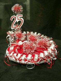 a red and white basket with some decorations on the top that says twenty five years