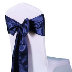 the back of a white chair with a blue bow on it's sashing