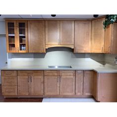 a kitchen with wooden cabinets and white counter tops