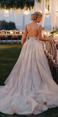 the back of a woman's dress is shown in front of an outdoor setting