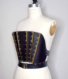 All items are lovingly handmade to your specifications after your order, so please allow up to 3 weeks production time before your order ships! Dramatic strapless leather bodice top with paneled front in a fan-like design accented with long gold bars and gold rivets. Has a gently curved neckline that stands away from the body. Made from smooth Italian cow leather available in black, red or burgundy. Bodice closes with two large buckled straps in the back. **Spot clean only w/ leather cleaner/con Art Deco Witch, Goth Art Deco, Queen Goddess, Witch Queen, Black Leather Top, Bodice Top, Goth Art, Leather Corset, Leather Harness