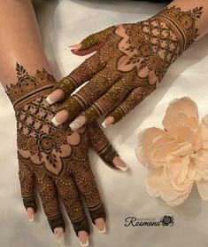 the hands and feet of a woman are decorated with henna designs on their palms