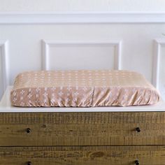 a bed sitting on top of a wooden dresser