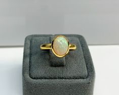 Certificated Natural Opal Dainty Cabachon Ring * 14K Solid Gold & Genuine Opal Stone * Best Gift for her * Handmade Ring ◎ Details ◎ ○ Gemstone Details .Natural OPAL Oval Cut 10.16X8.09 mm approx. 1.53 ct ○ Gold Details 14K Solid Gold Width of Band : 3.00 mm Weight of Ring : approx 4.60 gr Made to Order HANDMADE ITEM ○ Upgrade to Solid 18K Gold, please click the link below: https://www.etsy.com/listing/962826004 ◎ For more CABACHON BEZEL rings : http://etsy.me/37fvI60 All of our jewelleries Dainty Band, Topaz Color, Bezel Ring, Best Gifts For Her, Unisex Ring, Opal Stone, Dainty Ring, Natural Opal, Gold Details