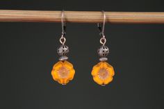 "Small, lightweight orange Czech glass earrings made with antique copper filigree ball and antique copper findings. Very feminine, these pretty small dangle earrings are made with lovely shades of orange brownish Czech glass flower beads and antique copper findings. These floral earrings are very small ( 1 1/4\" ), lightweight, bright and very charming. They hang from antique copper lever backs ( lead and nickel free ).  Color :  12mm Orange Picasso Hawaii Flower Beads, Opaque, Czech Glass Beads, Hibiscus, Pansey Finish : Antiqued copper findings Size : 1,5 inches including the antiqued copper lever back Ear wires : Antiqued copper lever back Czech glass earrings : https://www.etsy.com/shop/NtikArtJewelry?section_id=16062218&ref=shopsection_leftnav_5 To visit my shop : https://www.etsy.com Nickel-free Orange Flower Earrings, Vintage Orange Earrings With Czech Glass, Vintage Orange Czech Glass Earrings, Orange Copper Drop Earrings, Nickel Free Copper Orange Earrings, Nickel-free Copper Orange Earrings, Vintage Brown Flower Earrings, Nickel-free Orange Copper Earrings, Elegant Orange Copper Earrings